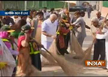 pm narendra modi wields broom as part of swachh bharat abhiyan
