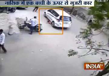 nashik three year old girl escapes after being run over by a car watch video