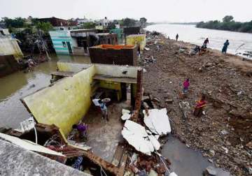 life limps back to normalcy in flood hit chennai massive clean up operation on