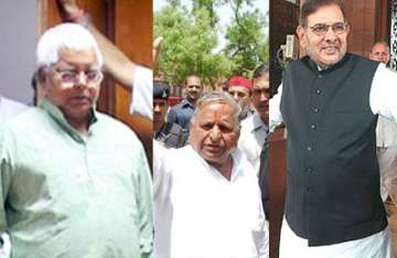 yadav trio ask pm to defer women s bill call all party meet