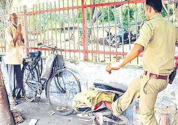 caught on camera up cop smashes elderly man s typewriter suspended