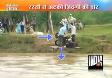 people in up cross a river using a jugaad ropeway