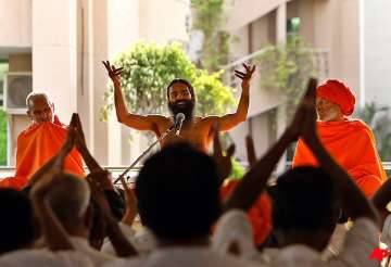 ramdev forgives pm cong accuses him of being rss agent