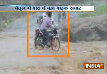 shocking video youth swept away by rain swollen river