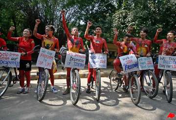 tibetan exiles hold rally following suicide of 2 buddhist monks