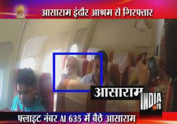 with eyes closed asaram with a rosary chanted mantra on indore delhi flight