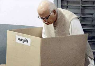 advani casts vote in gujarat parries queries on modi