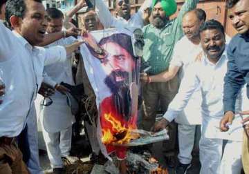 bsp activists burn effigies of baba ramdev