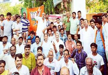 bjp staged dharnas demanding arrest of ips officer