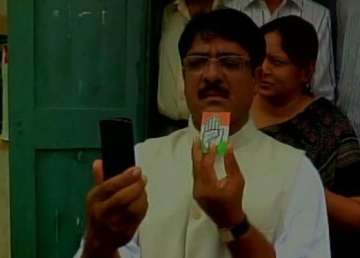 congress candidate from vadodara in trouble for flashing party symbol outside polling both