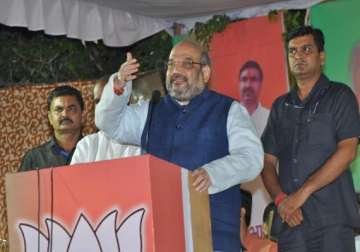 jharkhand polls amit shah accuses congress of looting jharkhand