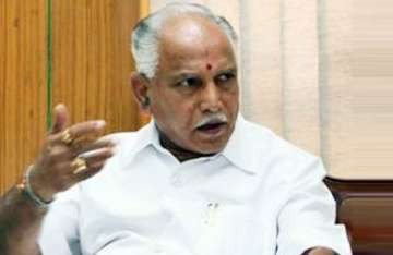 karna cm defends land allotment to family members