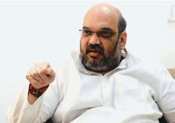 delhi polls amit shah attacks arvind kejriwal over bribery remark