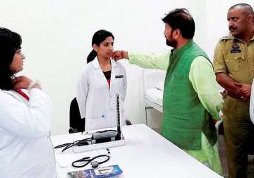 photo of bjp minister touching woman doctor s collar goes viral