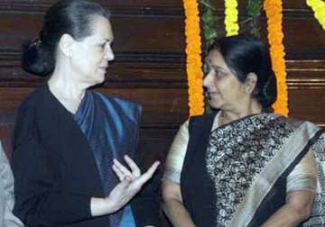 with arm around sushma s shoulder sonia reaches out