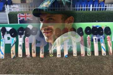 cricket legends join fans in a touching put out your bats tribute to phillip hughes