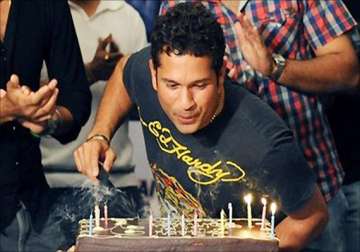 tense tendulkar cuts 40th birthday cake thanks fans
