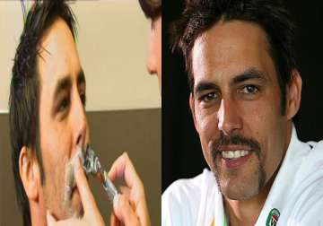 mitchell johnson sacrifices his famous handlebar moustache for charity