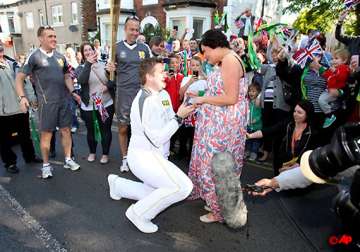 olympic torch bearer proposes during relay