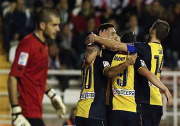 atletico wins 4 2 at rayo to move top of league