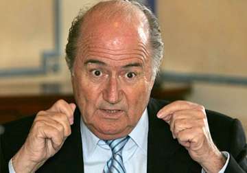 blatter sorry for racism remarks but won t quit