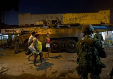 brazil security forces raid rio slum before wcup