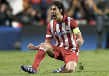 atletico beats malaga 3 1 to stay in hunt in spain