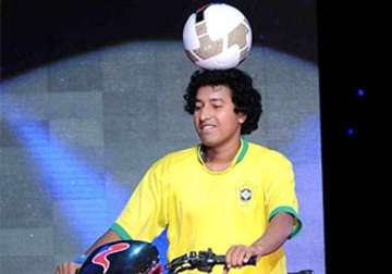 juggler uttam das to ride bike with football on his head in nahan