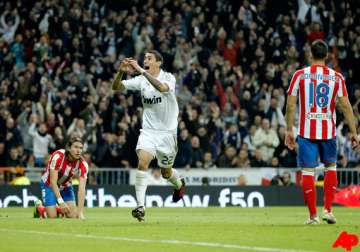 madrid beats atletico 4 1 to stay top in spain