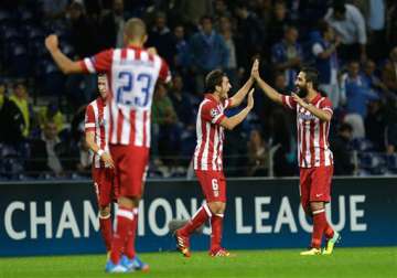 turan goal gives atletico madrid 2 1 win at porto