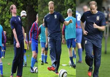 prince william wears wayne rooney s orange boots plays soccer watch pics