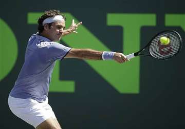 federer edges karlovic with strong serve at sony open.
