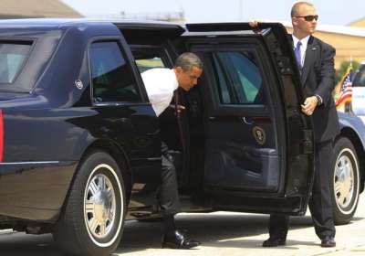 Security personnel surround the official vehicle of Indian Prime