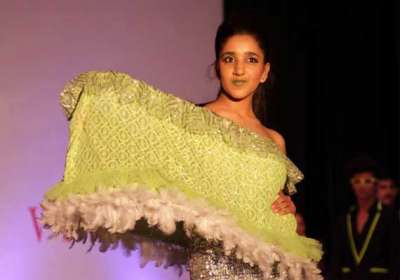 A model displays a designer fusion wear at an  India Fashion