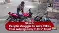Watch: People struggle to save bikes from swiping away in flash flood