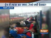 Watch: Passengers travelling while hanging out from train in Bhiwani