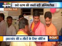 Manoj Tiwari, BJP candidate from North-East Delhi stands in a queue to cast his vote