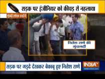 Congress leader Nitesh Rane throws mud on a highway engineer