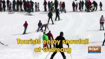 Tourists enjoy snowfall at Gulmarg