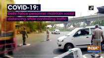 COVID-19: Delhi Police personnel maintain social distancing while controlling traffic