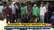 Assamese migrant workers wait at roadside in Chennai for their turn to get home