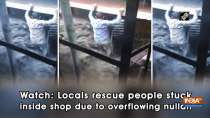Watch: Locals rescue people stuck inside shop due to overflowing nullah