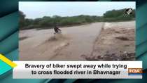 Bravery of biker swept away while trying to cross flooded river in Bhavnagar