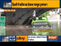 Bus half submeged in waterlogged road under Minto Bridge following downpour in Delhi