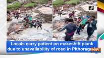 Locals carry patient on makeshift plank due to unavailability of road in Pithoragarh
