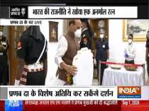 Defence Minister Rajnath Singh pays last respects to former President Pranab Mukherjee at his residence