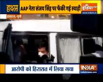 An unidentified person throws ink at the AAP leader Sanjay Singh