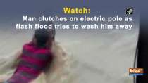 Watch: Man clutches on electric pole as flash flood tries to wash him away