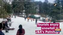 Tourists enjoy snowfall in J&K