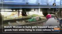 Watch: Woman in hurry gets trapped beneath goods train while trying to cross railway track